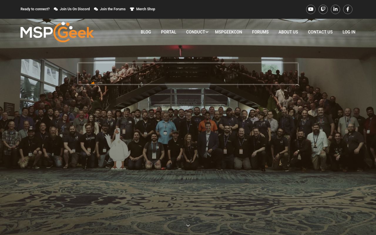 MSPGeek homepage showing a wide group photograph from MSPGeekCon, above navigation to the forums, portal and Discord