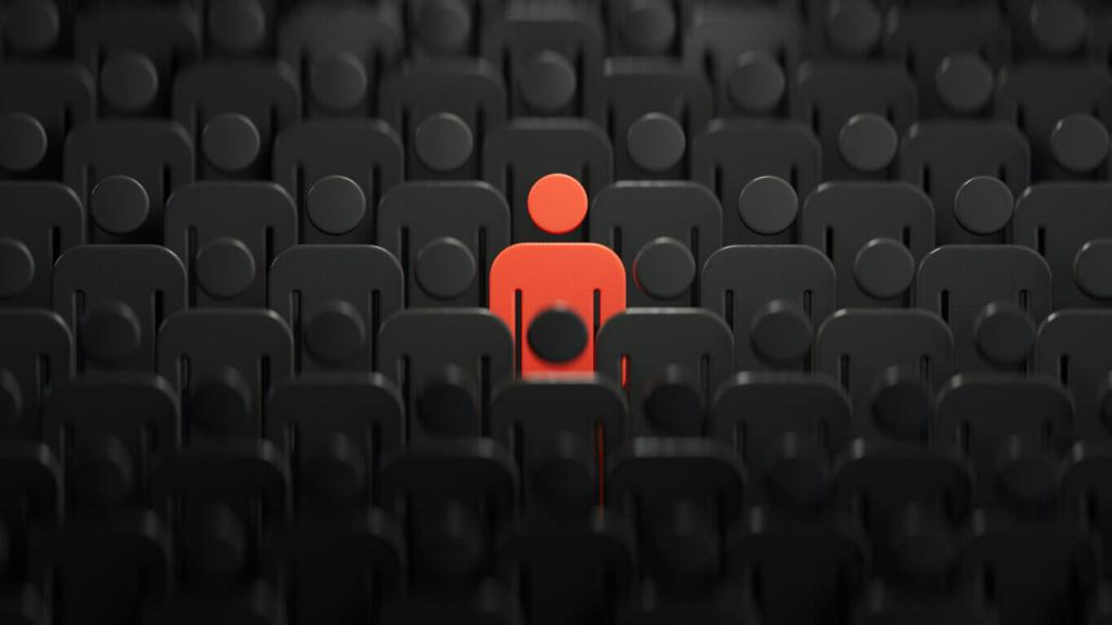Illustration of a red human shape standing out in a crowd of black human shapes, explaining the importance of identifying your target audience in social media app marketing.